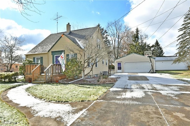 bungalow-style house with a garage, an outdoor structure, and a front yard