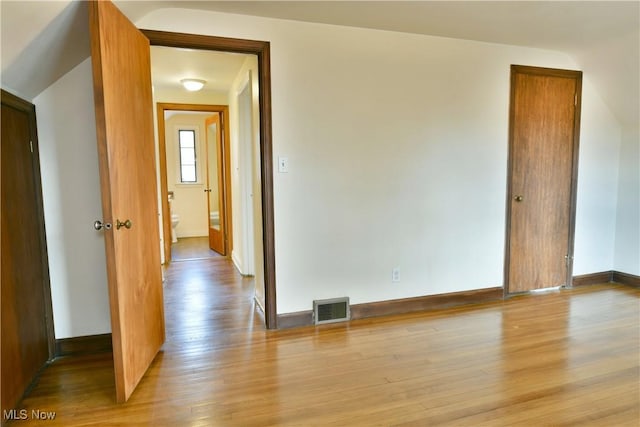 unfurnished room with light wood-type flooring