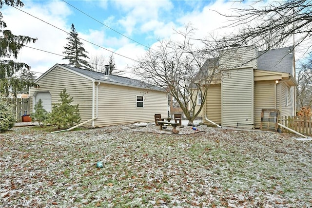 rear view of house with a garage