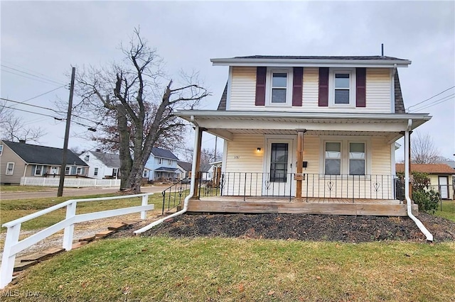 view of front of property with a porch and a front yard