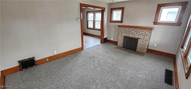 unfurnished living room featuring carpet floors and a fireplace