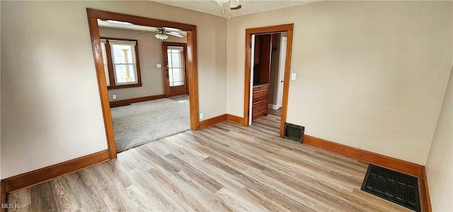 1151 Bedford Ave SW, Canton, OH 44710 - spare room featuring visible vents, ceiling fan, light wood-style floors, and baseboards