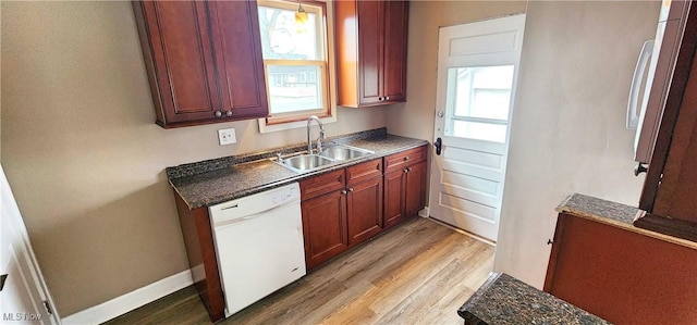 1151 Bedford Ave SW, Canton, OH 44710 - kitchen featuring dark countertops, light wood-style floors, dishwasher, and a sink