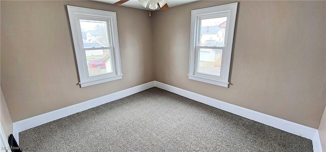 1151 Bedford Ave SW, Canton, OH 44710 - unfurnished room featuring baseboards, a ceiling fan, carpet, and plenty of natural light