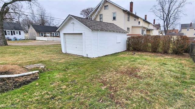 1151 Bedford Ave SW, Canton, OH 44710 - rear view of house with a garage, an outdoor structure, a yard, roof with shingles, and fence