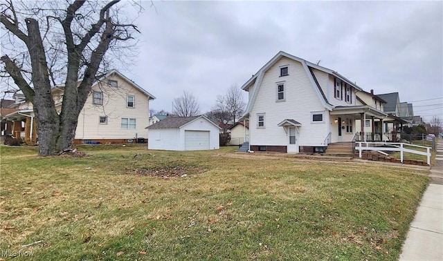 1151 Bedford Ave SW, Canton, OH 44710 - view of side of home with a gambrel roof, an outbuilding, covered porch, a detached garage, and a lawn