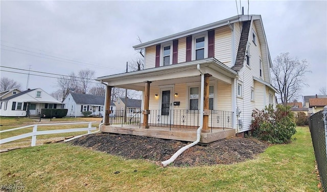 1151 Bedford Ave SW, Canton, OH 44710 - view of front of house with covered porch, fence, a residential view, and a front yard