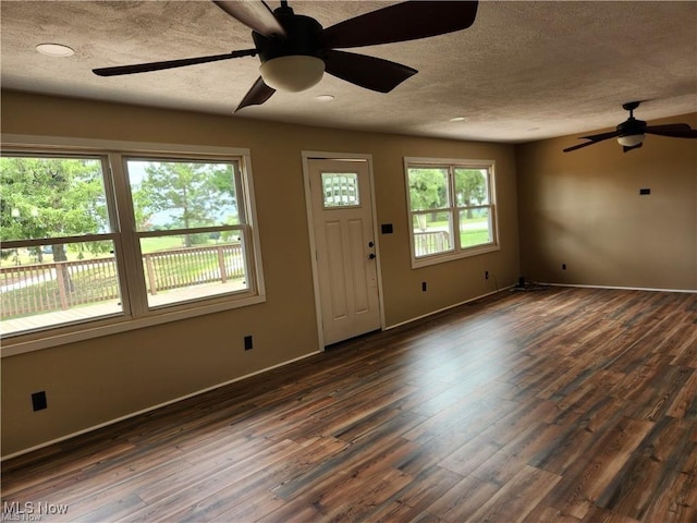 entrance foyer featuring dark hardwood / wood-style flooring and a textured ceiling