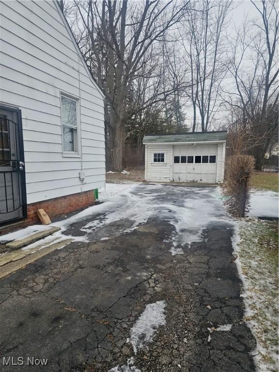 view of property exterior with a garage and an outdoor structure