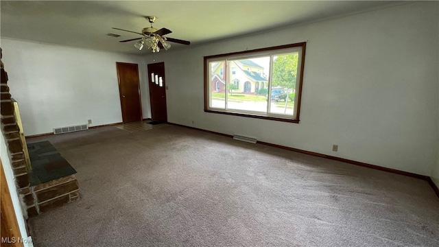 unfurnished living room featuring ceiling fan and carpet