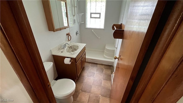 bathroom featuring vanity, toilet, and walk in shower