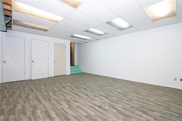 basement with wood-type flooring and a drop ceiling