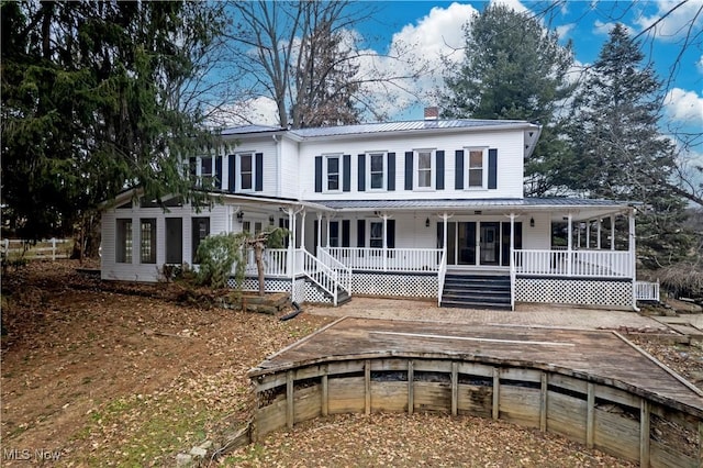 back of property featuring covered porch