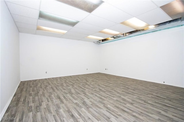 basement featuring hardwood / wood-style flooring and a paneled ceiling