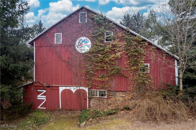 view of property exterior featuring an outbuilding