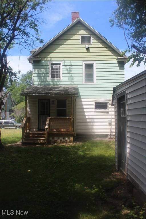 back of house with a yard