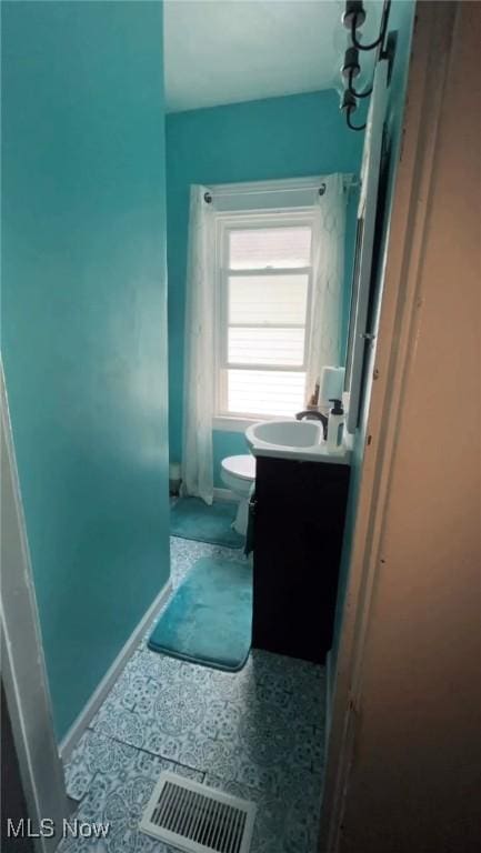 bathroom featuring vanity and toilet