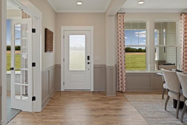 entryway featuring crown molding and light hardwood / wood-style flooring