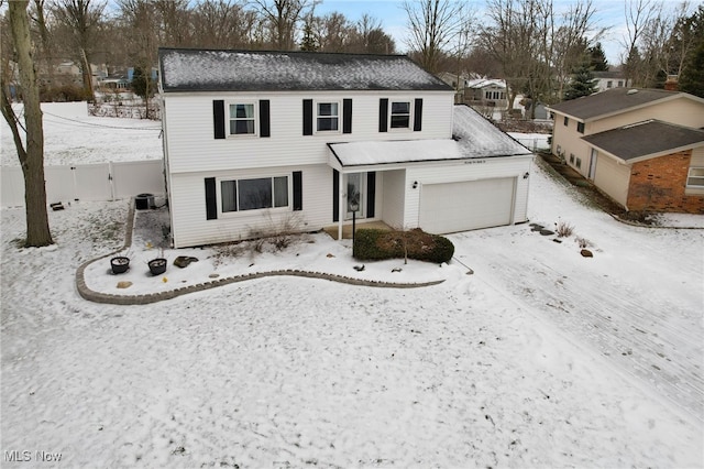 view of front property with a garage and central AC