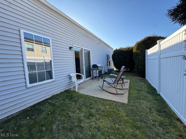 view of yard featuring central AC and a patio area