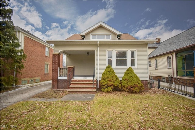 view of front facade with a front lawn and a porch