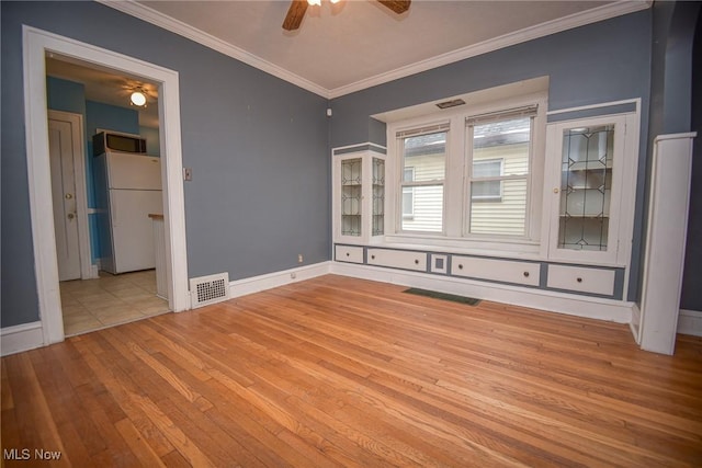 spare room with ornamental molding, light hardwood / wood-style floors, and ceiling fan