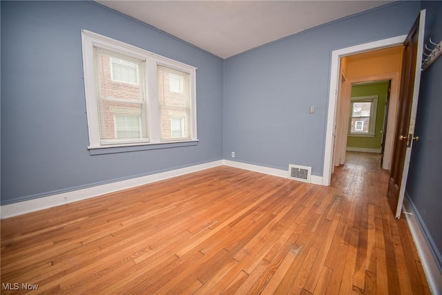 spare room with light wood-type flooring