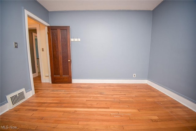 unfurnished room with light wood-type flooring