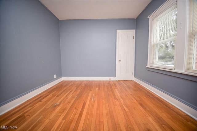 empty room with light hardwood / wood-style flooring