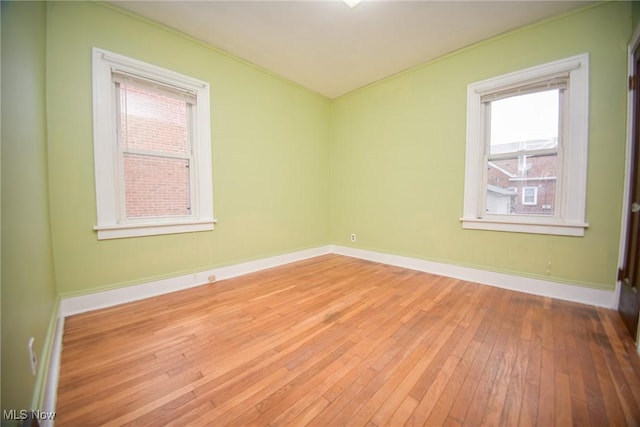 spare room with hardwood / wood-style flooring