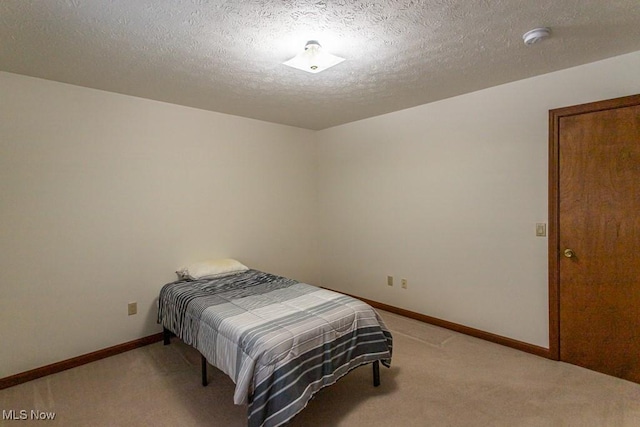 carpeted bedroom with a textured ceiling