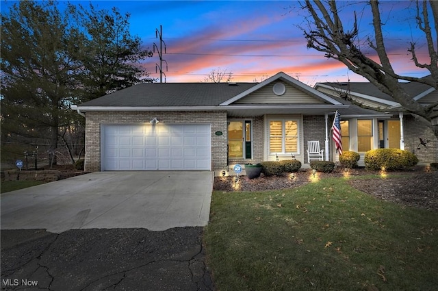 view of front of property featuring a garage and a yard