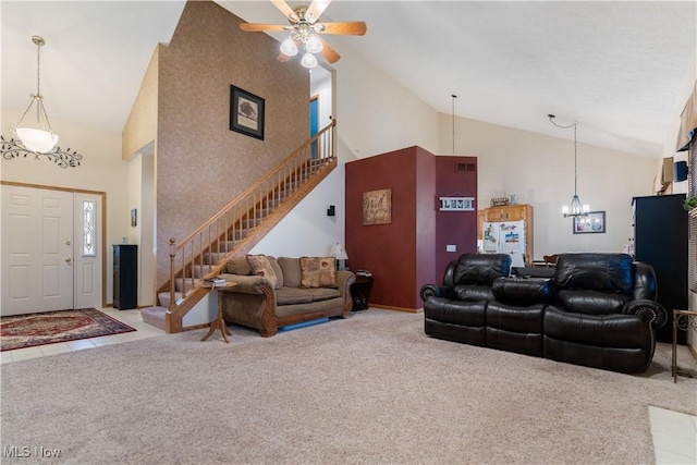 carpeted living room featuring ceiling fan with notable chandelier and high vaulted ceiling