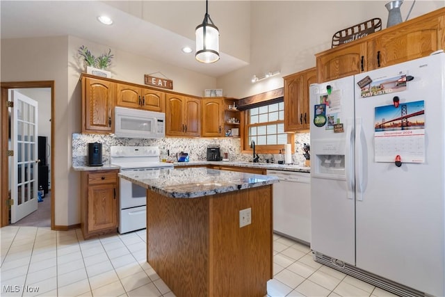 kitchen with a kitchen island, pendant lighting, sink, decorative backsplash, and white appliances