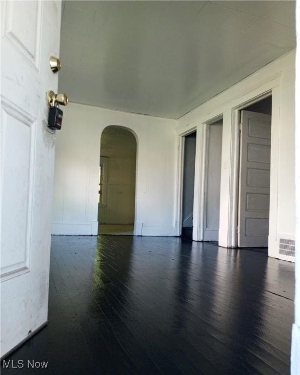 unfurnished room featuring dark hardwood / wood-style floors