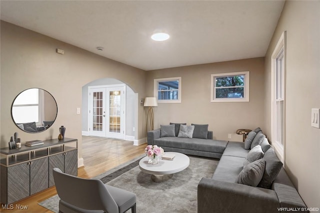 living room with light hardwood / wood-style floors and french doors