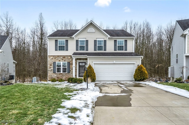 view of front of property featuring a garage and a front lawn