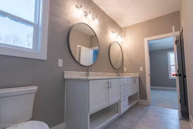 3672 Williams Ct, Avon, OH 44011 - bathroom featuring toilet, baseboards, tile patterned floors, a sink, and double vanity