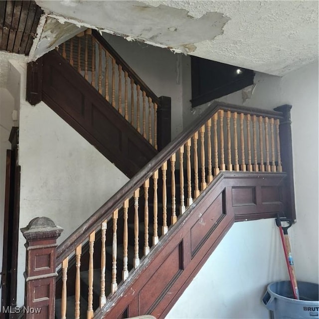 stairway with a textured ceiling