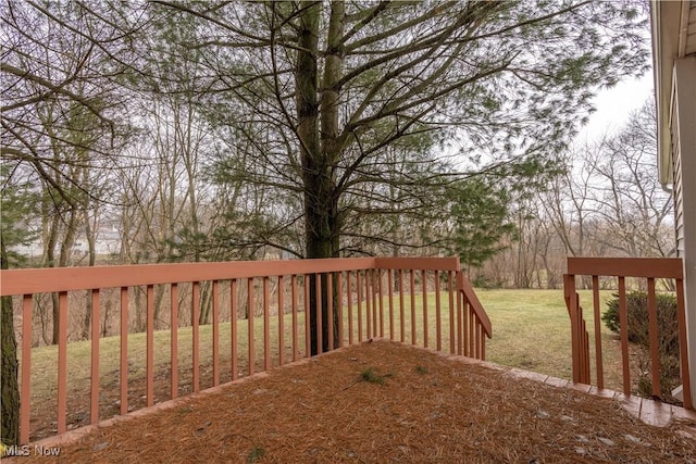 wooden terrace featuring a yard