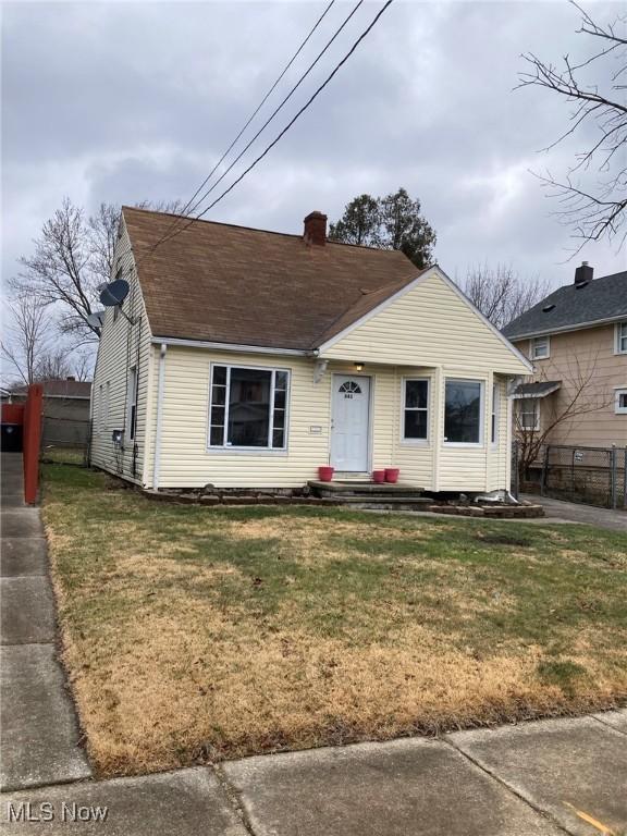 bungalow-style home with a front lawn