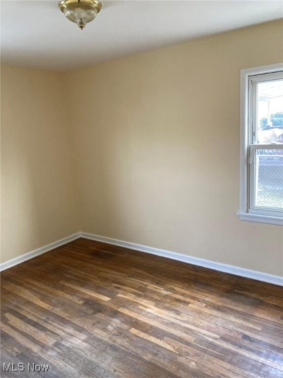 empty room with dark wood-type flooring