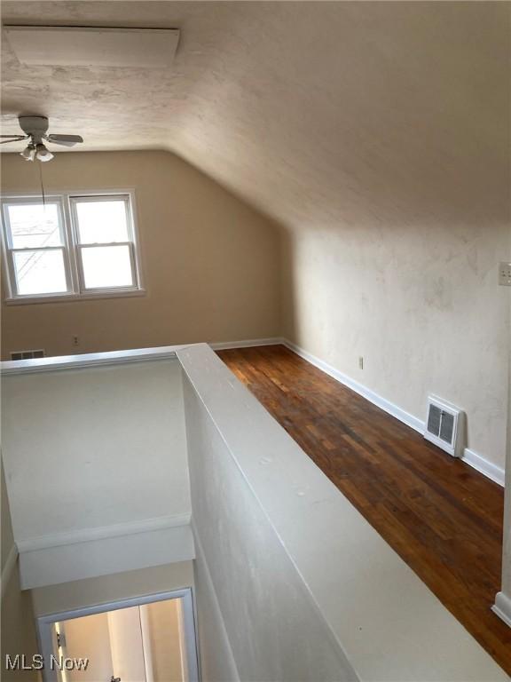 bonus room with hardwood / wood-style flooring, ceiling fan, and vaulted ceiling