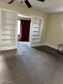 unfurnished room featuring a healthy amount of sunlight, ceiling fan, and built in shelves