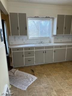 kitchen with gray cabinetry and sink