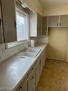 kitchen featuring sink and decorative backsplash