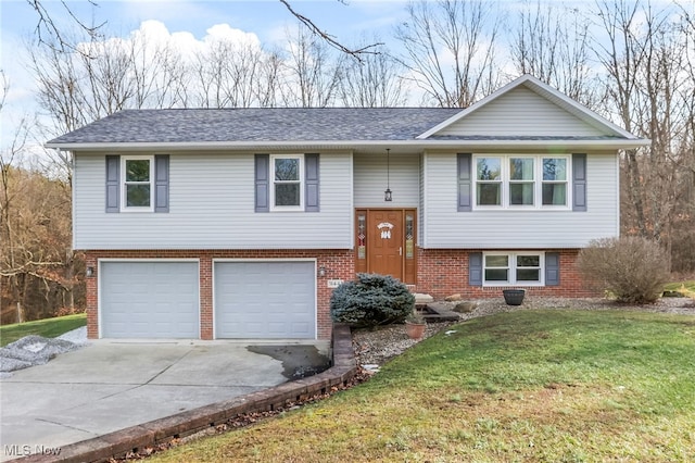 bi-level home with a garage and a front yard