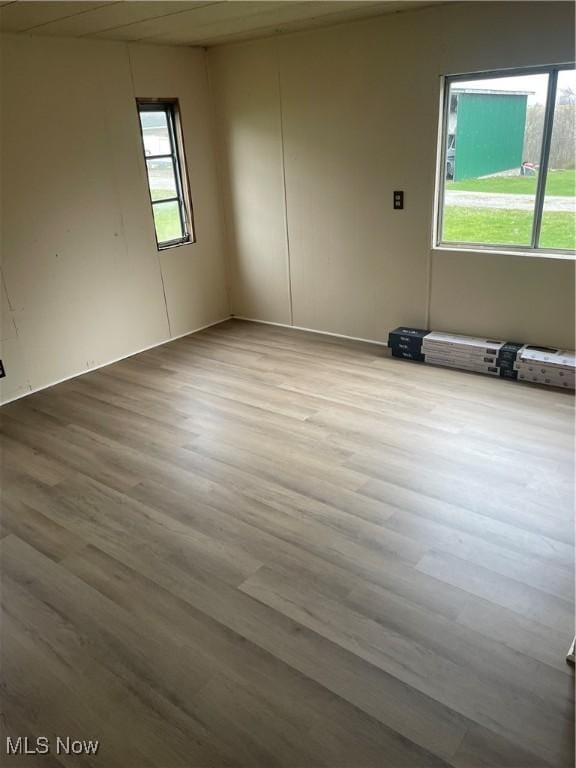 unfurnished room with light wood-type flooring