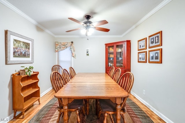 dining space featuring hardwood / wood-style flooring, crown molding, and ceiling fan