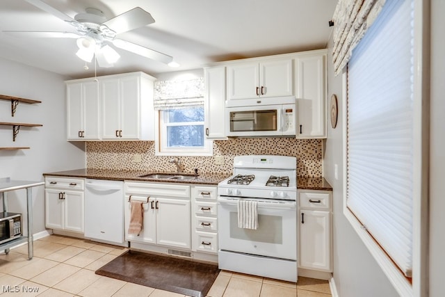 kitchen featuring white cabinetry, sink, and white appliances